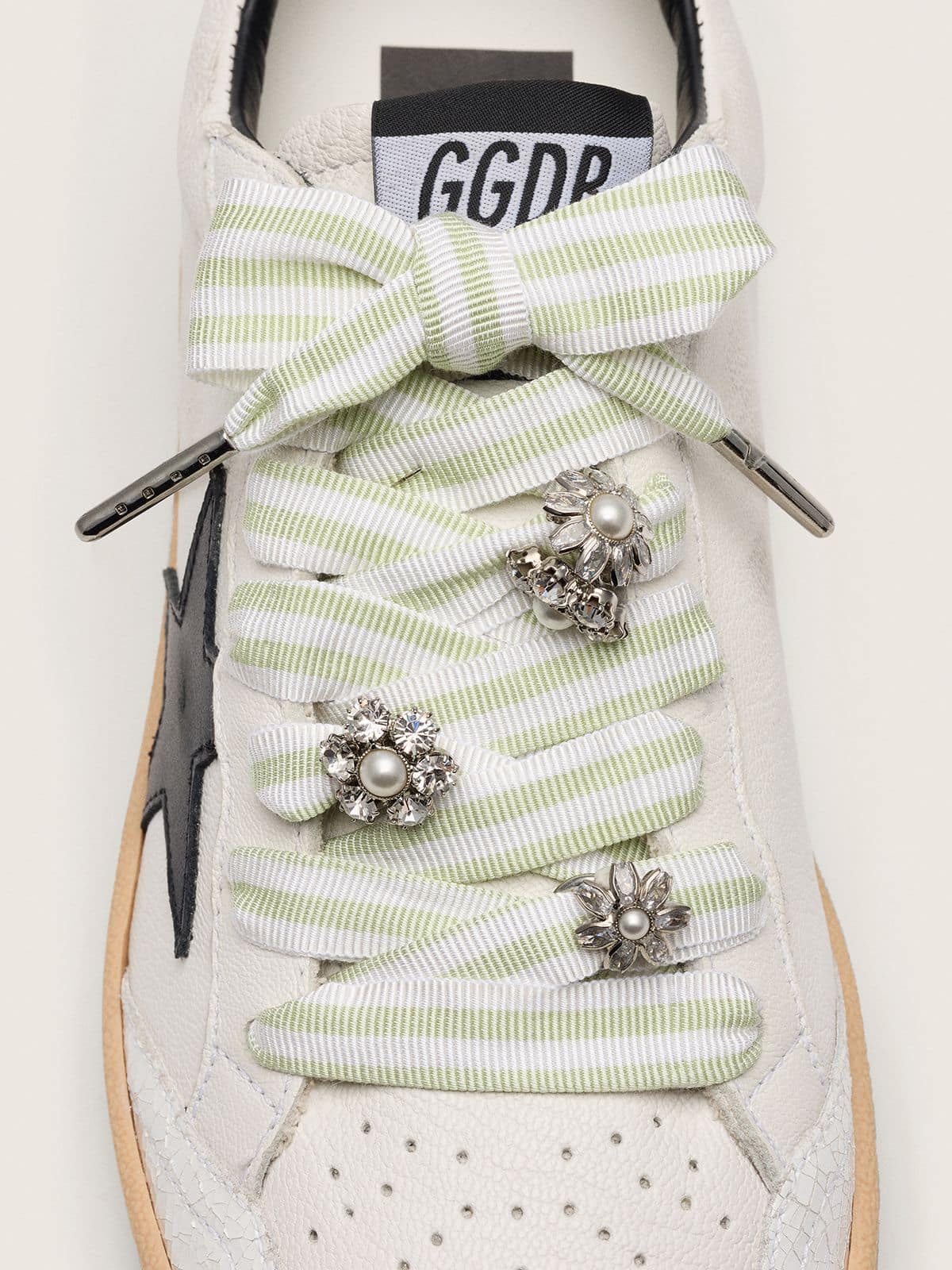 Skins green and white striped laces with jewel charms