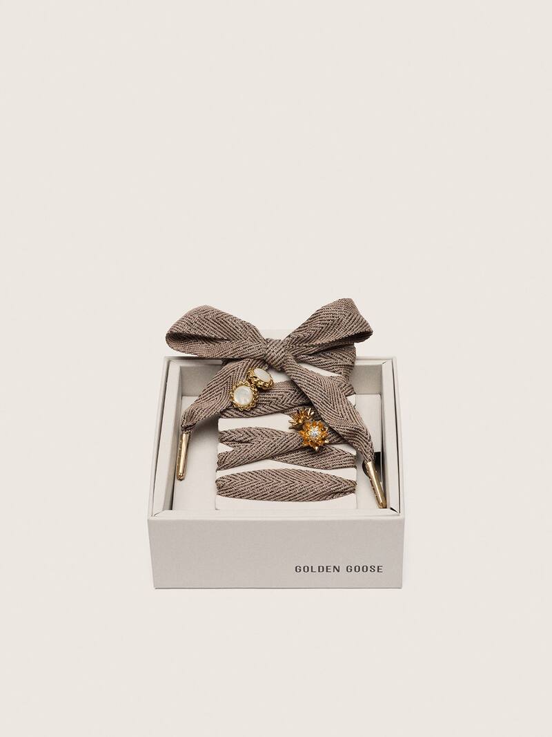 Skins brown and white laces embellished with gold charms