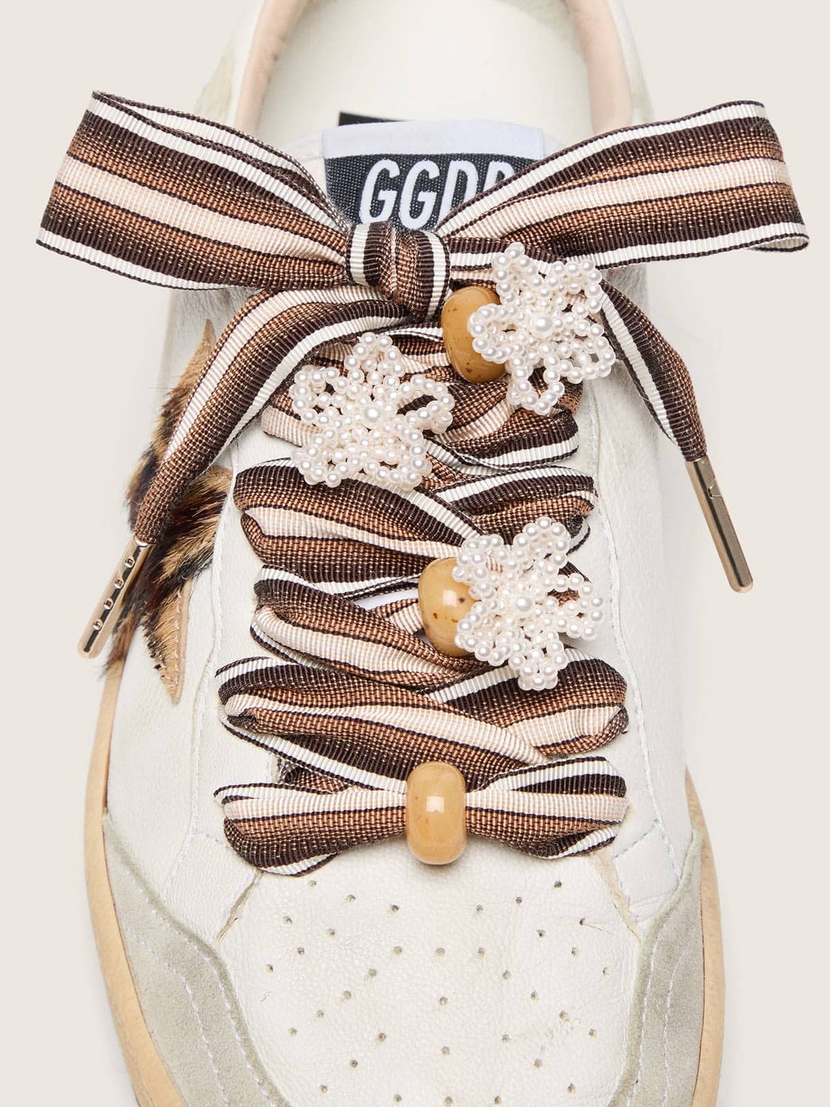 Skins brown striped laces with flower-shaped bead appliqu&eacute;s