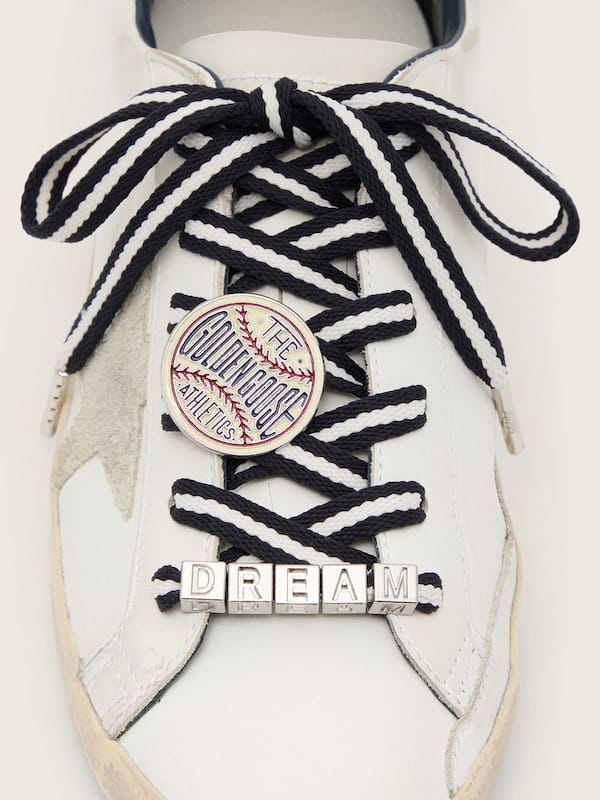 Skins cream and dark blue striped laces with pin and silver appliqu&eacute;