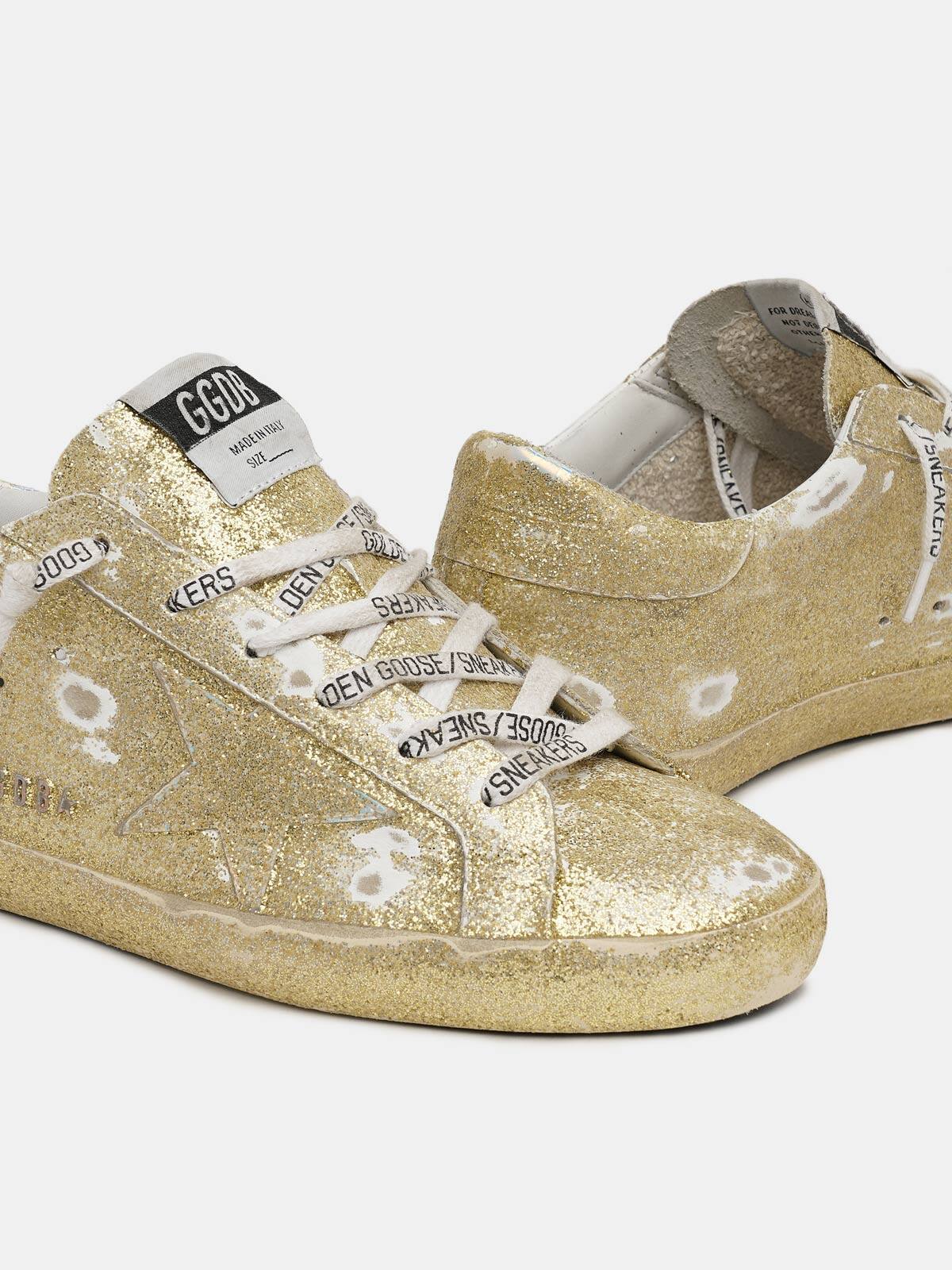 Golden Goose - Sparkling Super-Star sneakers with gold glitter and logoed laces in 