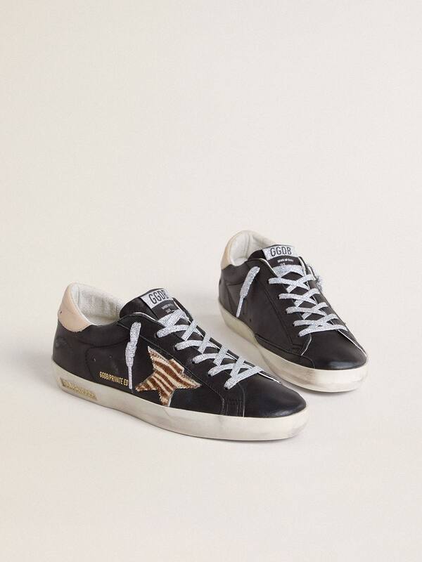 Golden Goose - Women’s Super-Star in black nappa leather with zebra-print pony skin star and beige leather heel tab in 