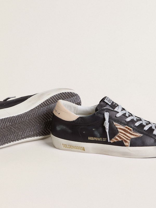 Golden Goose - Women’s Super-Star in black nappa leather with zebra-print pony skin star and beige leather heel tab in 