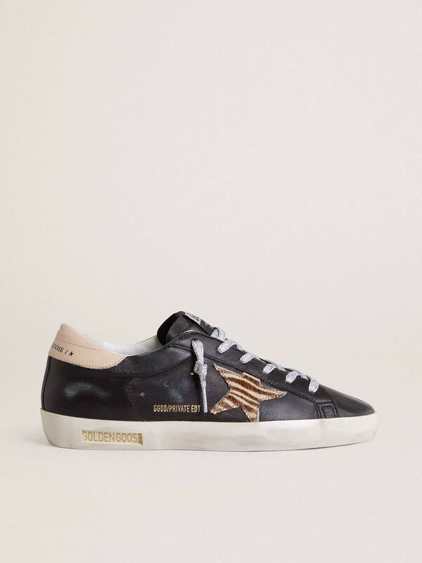 Golden Goose - Women’s Super-Star in black nappa leather with zebra-print pony skin star and beige leather heel tab in 