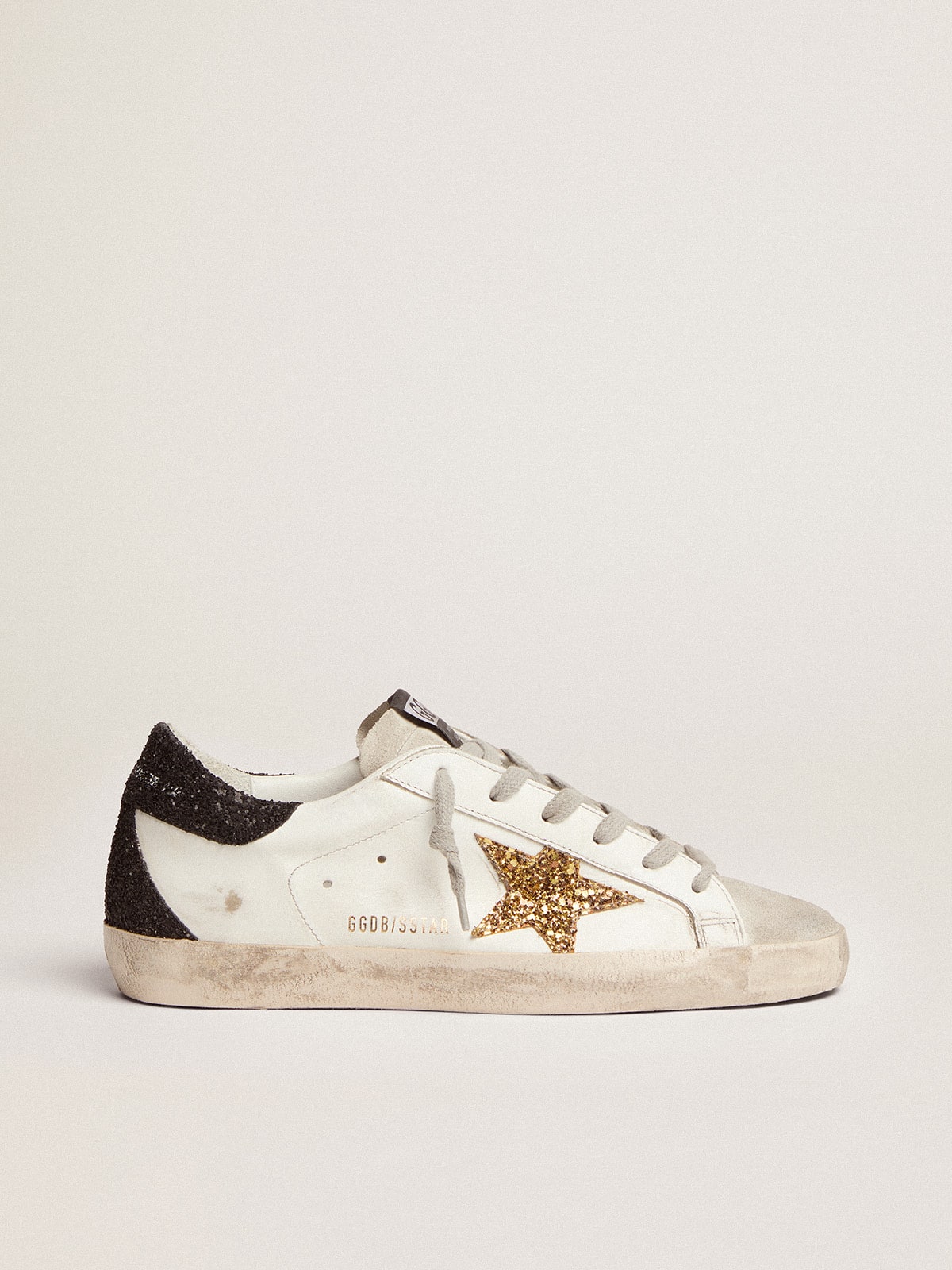 Women s Super Star LTD with gold star and black glitter heel tab Golden Goose