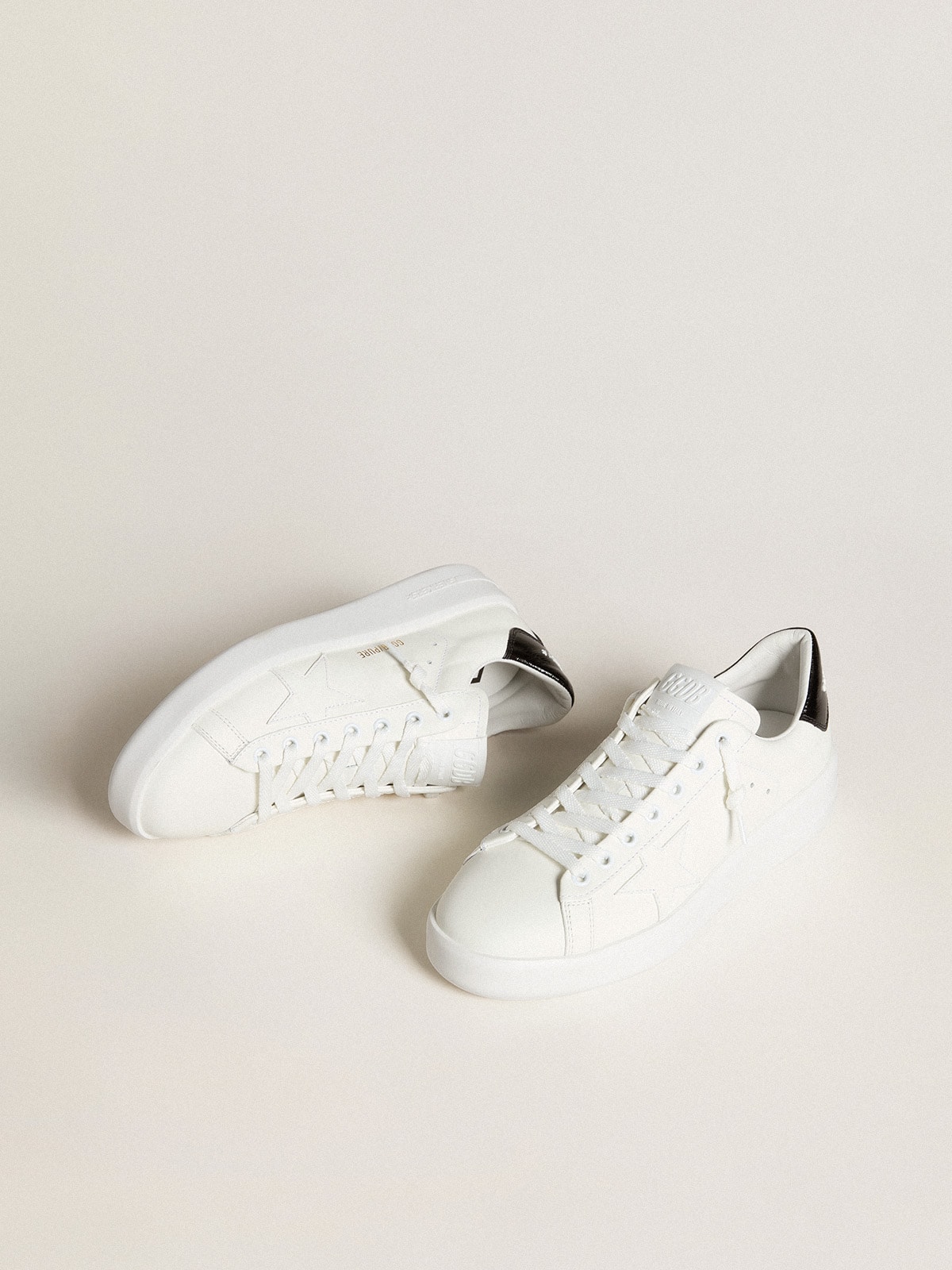 White sneakers with stars orders on them