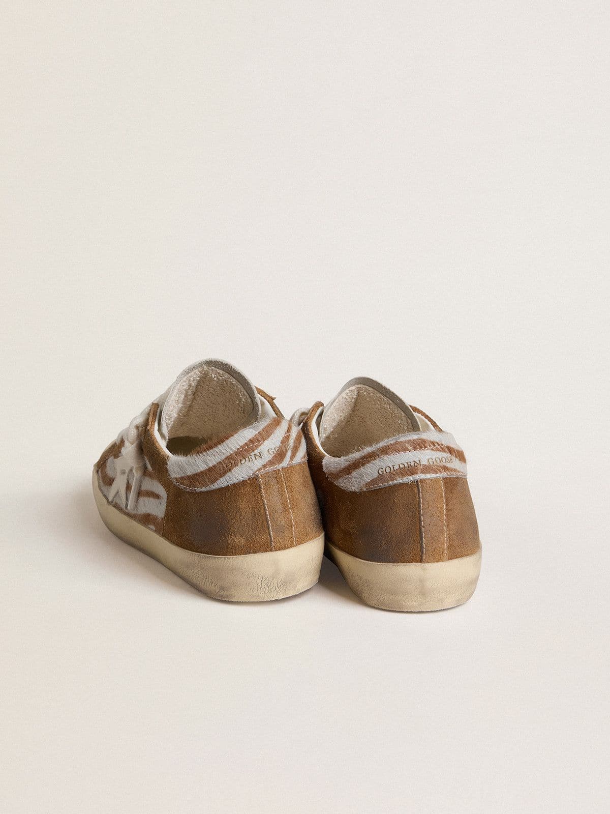 Golden Goose - Women's Super-Star in zebra-print pony skin with leather star and brown suede inserts in 