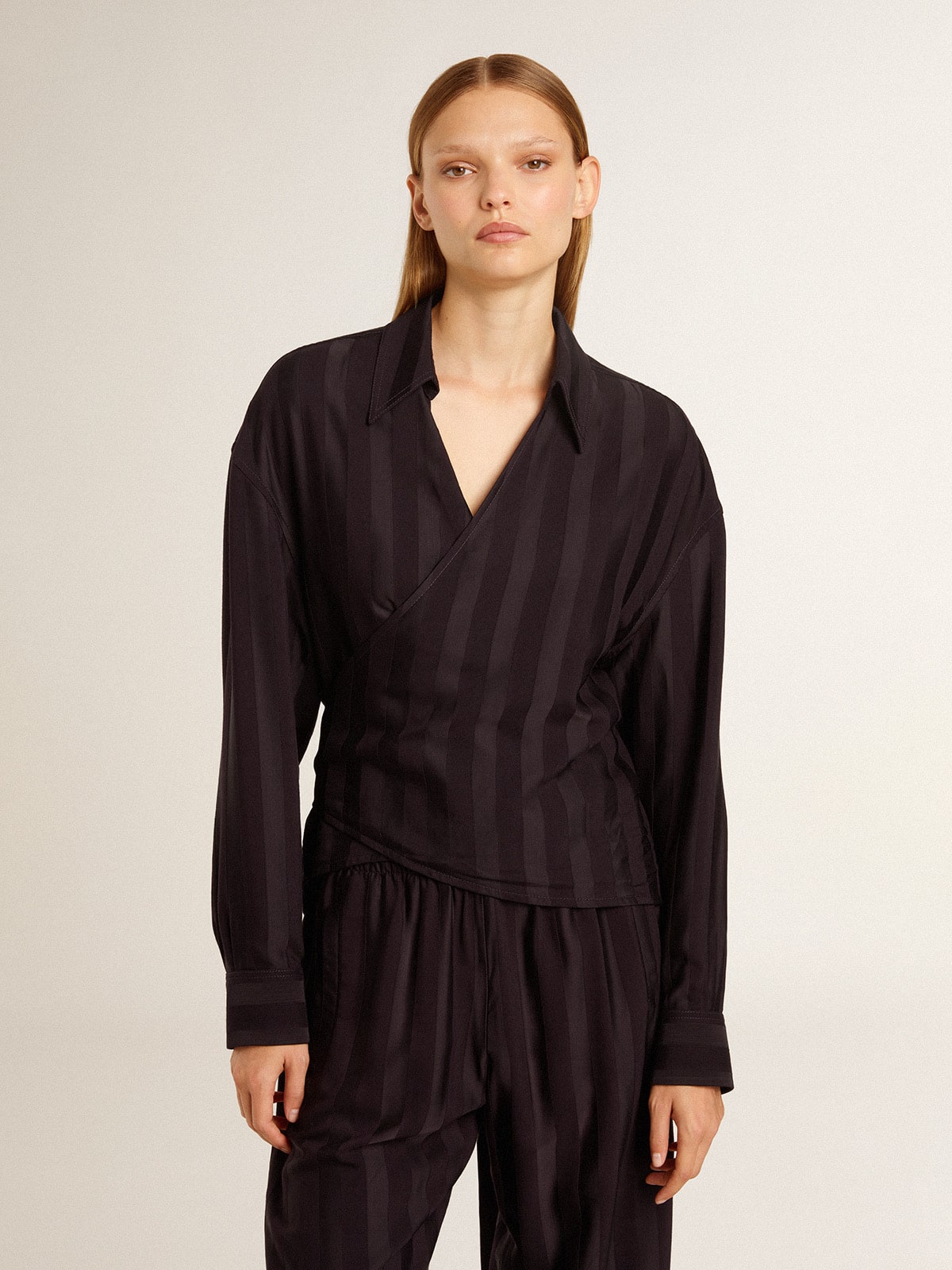 Women's black shirt with vertical stripes and side knot closure 