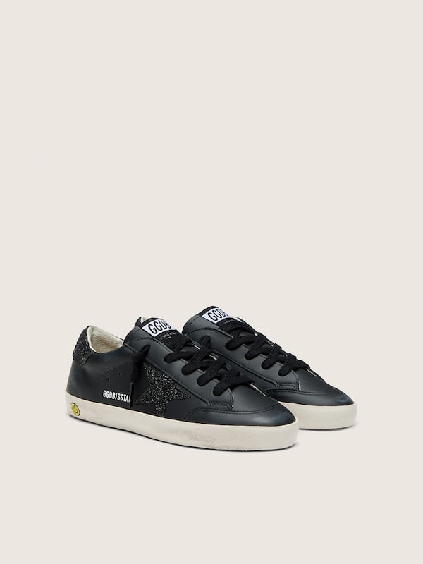 Young Super-Star in black leather with black glitter star